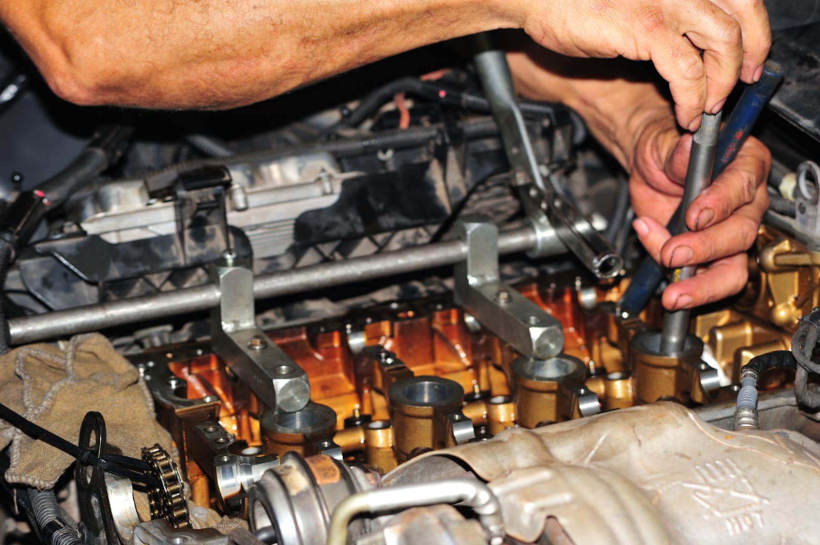 Técnico trabalhando no cabeçote de um motor com ferramenta especial